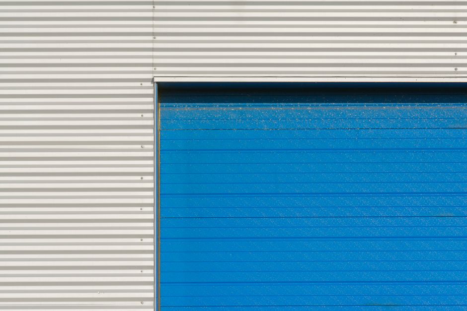 Simple blue and white industrial garage facade with modern design.