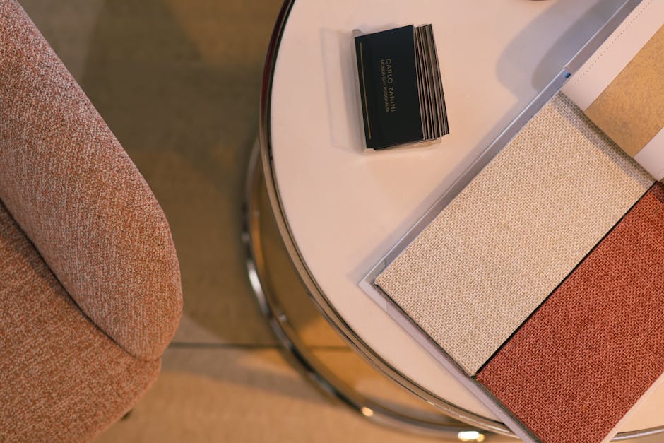 Fabric swatches and chair on a round table, perfect for interior design themes.