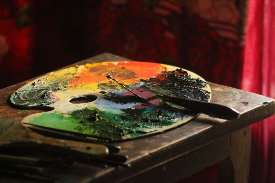 Close-up of a vibrant artist's palette filled with colorful paint, embodying creativity.