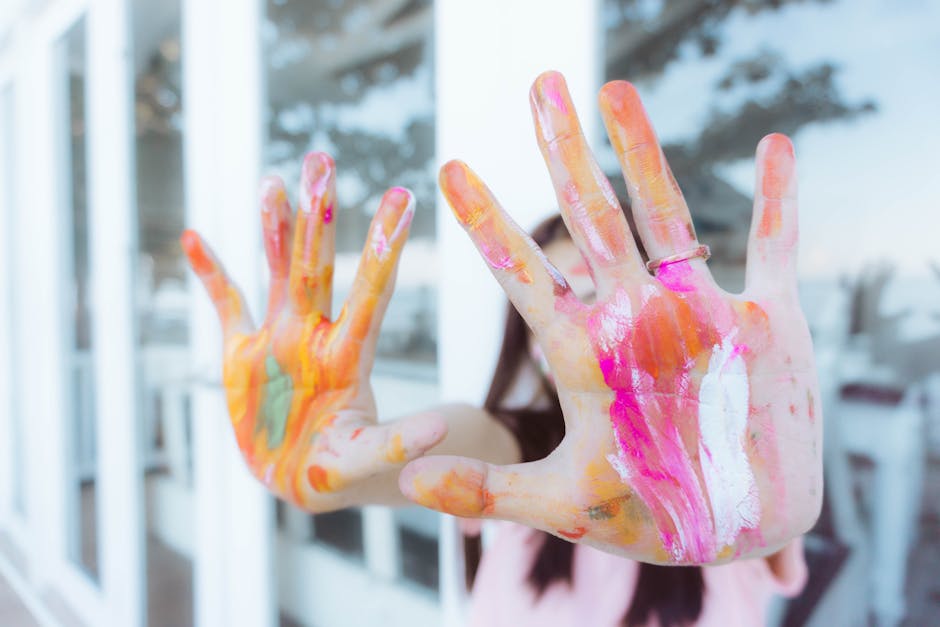 A close-up view of a child's colorful painted hands expressing creativity and playfulness.